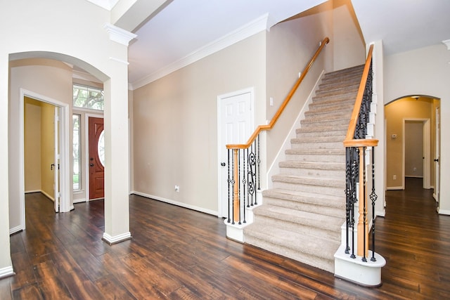 22602 Water Edge Ln, Katy, TX 77494 - entrance foyer with arched walkways, wood finished floors, ornamental molding, and stairs