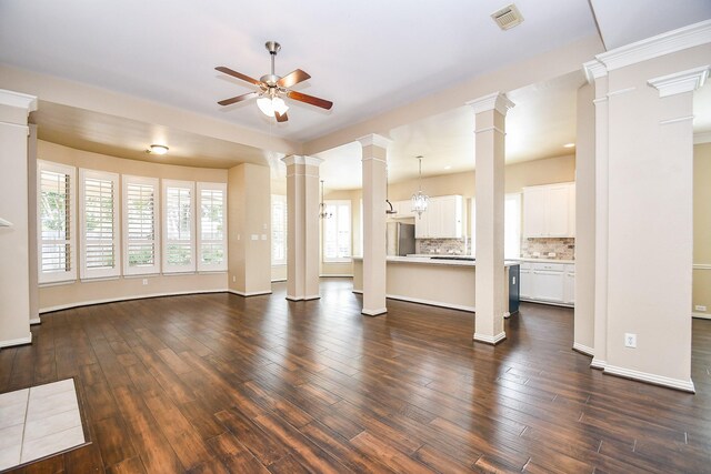 22602 Water Edge Ln, Katy, TX 77494 - unfurnished living room featuring ceiling fan, decorative columns, and dark wood finished floors