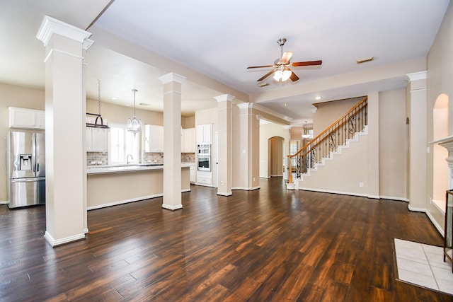 22602 Water Edge Ln, Katy, TX 77494 - unfurnished living room featuring ceiling fan, dark wood-style flooring, and stairs