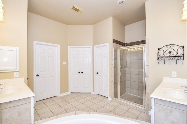 22602 Water Edge Ln, Katy, TX 77494 - bathroom with two vanities, a shower stall, tile patterned flooring, and a tub to relax in