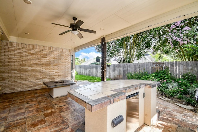 22602 Water Edge Ln, Katy, TX 77494 - fenced backyard featuring exterior kitchen, ceiling fan, and a patio area