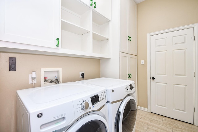 22602 Water Edge Ln, Katy, TX 77494 - laundry room featuring cabinet space, washing machine and clothes dryer, and wood tiled floors