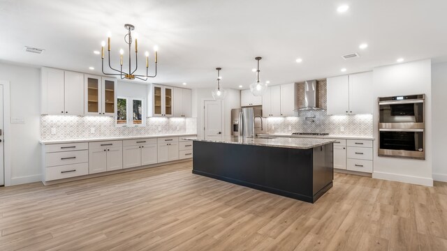 6414 Woodbrook Ln, Houston, TX 77008 - kitchen with wall chimney range hood, stainless steel appliances, backsplash, recessed lighting, and white cabinets