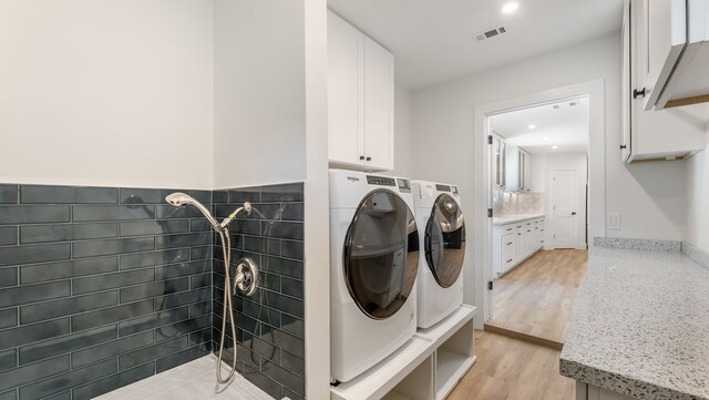6414 Woodbrook Ln, Houston, TX 77008 - washroom with washer and clothes dryer and light wood-style floors