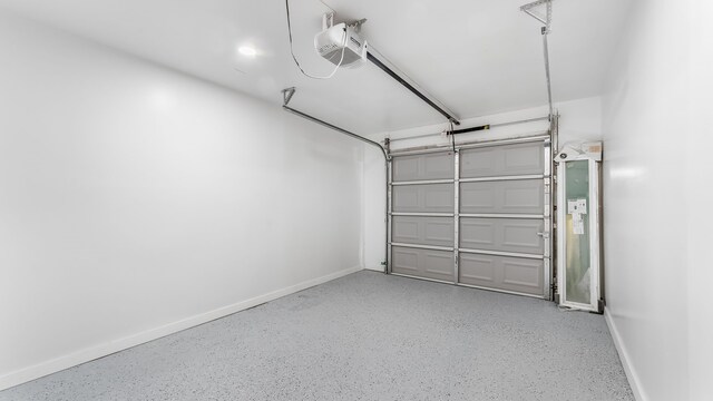6414 Woodbrook Ln, Houston, TX 77008 - garage featuring a garage door opener and baseboards