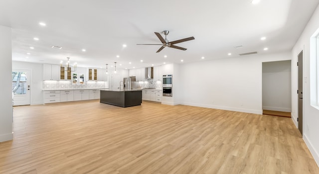 6414 Woodbrook Ln, Houston, TX 77008 - unfurnished living room featuring recessed lighting, ceiling fan, and light wood-type flooring