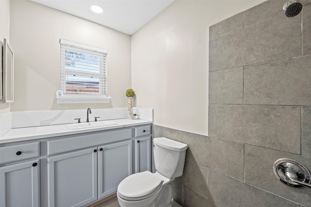 9614 Hammerly Blvd, Houston, TX 77080 - bathroom featuring vanity, wainscoting, tile walls, recessed lighting, and a tile shower