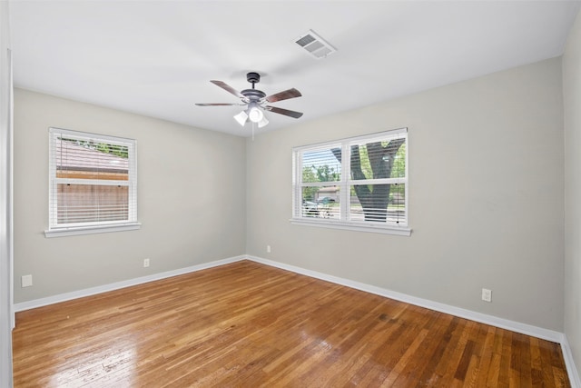 9614 Hammerly Blvd, Houston, TX 77080 - empty room with plenty of natural light, hardwood / wood-style flooring, and a ceiling fan