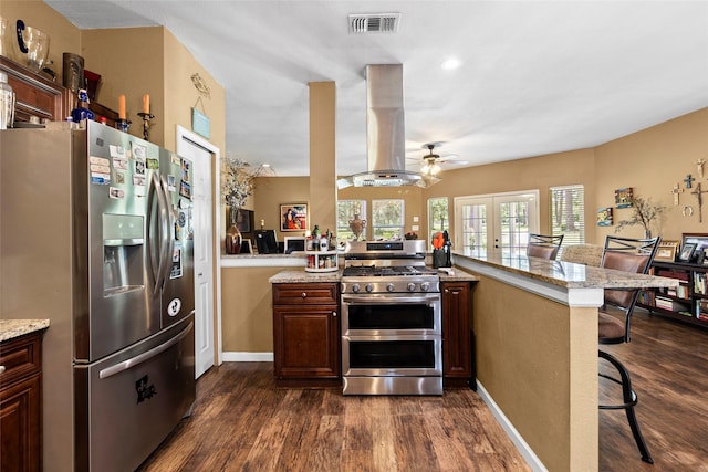 847 Cottletown Rd, Smithville, TX 78957 - kitchen with stainless steel appliances, island exhaust hood, french doors, dark wood-style flooring, and recessed lighting