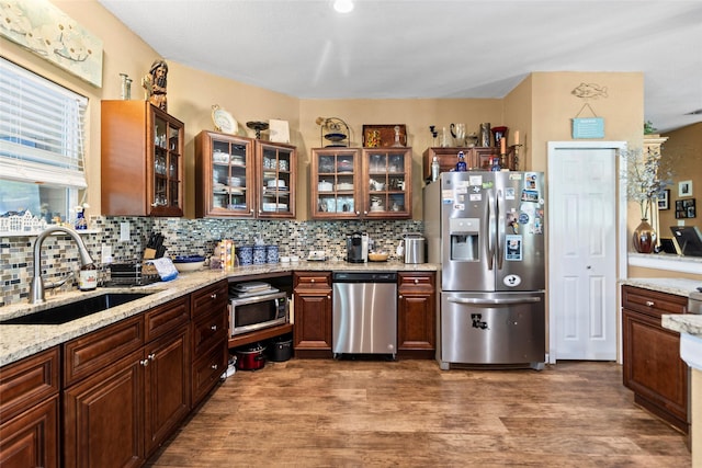847 Cottletown Rd, Smithville, TX 78957 - kitchen with appliances with stainless steel finishes, decorative backsplash, and wood finished floors