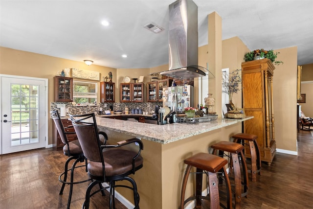847 Cottletown Rd, Smithville, TX 78957 - kitchen with island range hood, a peninsula, stainless steel fridge, glass insert cabinets, and dark wood-style floors