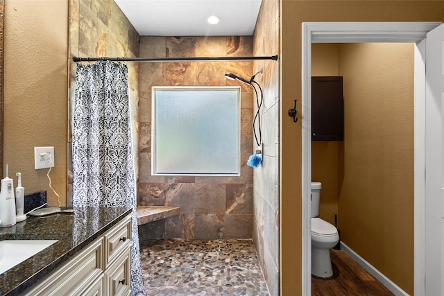 847 Cottletown Rd, Smithville, TX 78957 - full bathroom with tiled shower, vanity, and wood finished floors