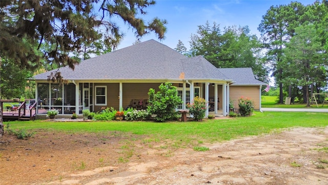 847 Cottletown Rd, Smithville, TX 78957 - view of front of home with a sunroom, a front yard, and roof with shingles