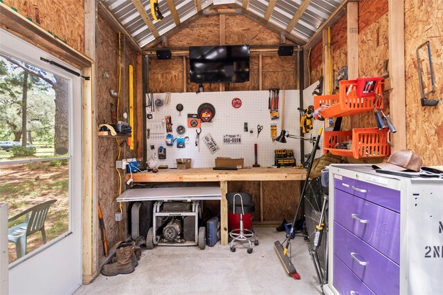 847 Cottletown Rd, Smithville, TX 78957 - miscellaneous room featuring a workshop area, lofted ceiling, and concrete flooring