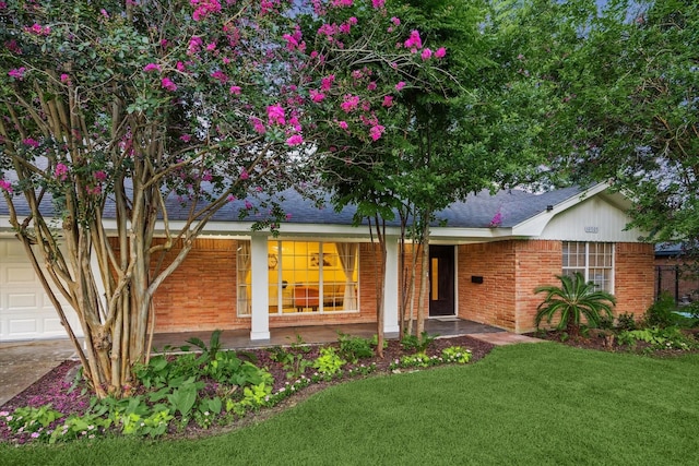 10707 Moonlight Dr, Houston, TX 77096 - single story home with brick siding, a front yard, covered porch, and a shingled roof