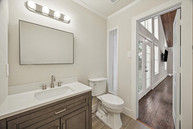 10707 Moonlight Dr, Houston, TX 77096 - bathroom featuring crown molding, vanity, and wood finished floors