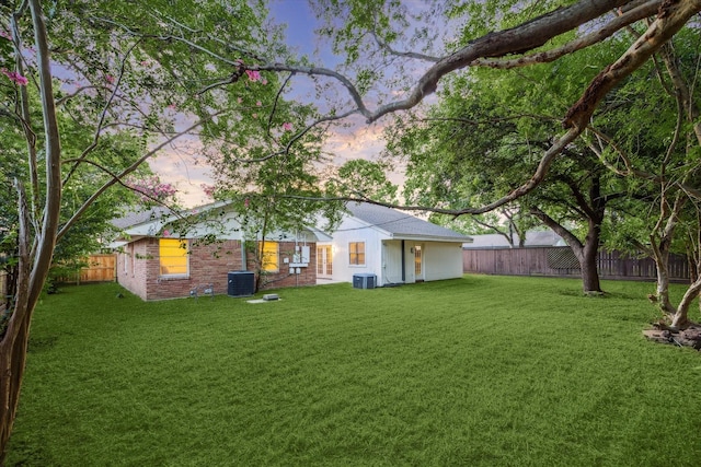 10707 Moonlight Dr, Houston, TX 77096 - yard at dusk featuring a fenced backyard