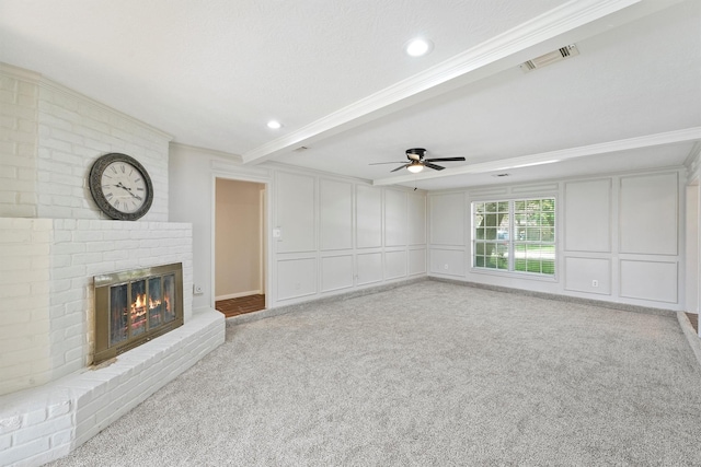 15002 Walters Rd, Houston, TX 77068 - unfurnished living room with a decorative wall, light colored carpet, a fireplace, ceiling fan, and beamed ceiling