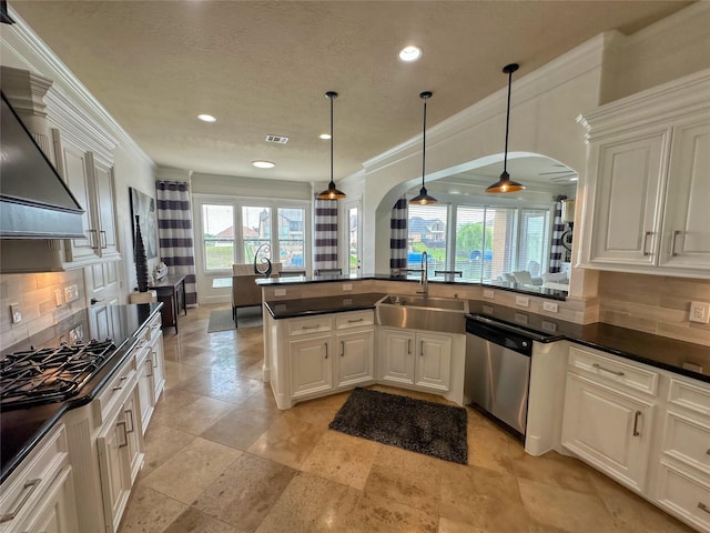 12571 St Ann Ct, Willis, TX 77318 - kitchen with stainless steel dishwasher, arched walkways, ornamental molding, dark countertops, and tasteful backsplash