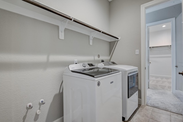 3207 Coach Horse Ln, Houston, TX 77080 - laundry area featuring washing machine and dryer, light colored carpet, and light tile patterned floors
