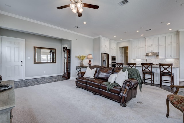 3207 Coach Horse Ln, Houston, TX 77080 - carpeted living room with ceiling fan, crown molding, recessed lighting, and wood finished floors
