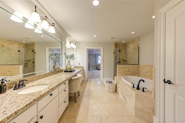 5531 Pine St Unit H, Houston, TX 77081 - bathroom with a shower stall, vanity, a bath, tile patterned floors, and recessed lighting