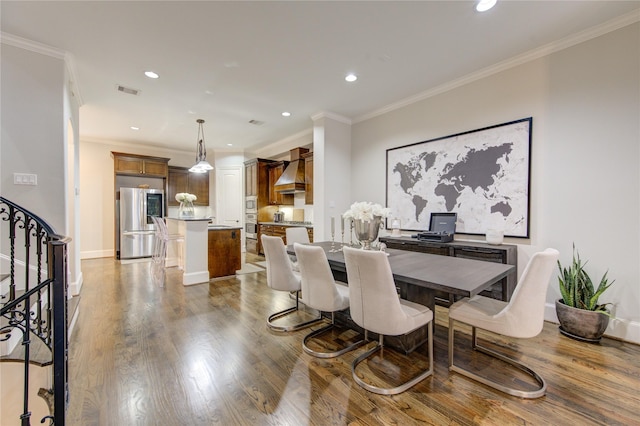 5531 Pine St Unit H, Houston, TX 77081 - dining area featuring ornamental molding, wood finished floors, recessed lighting, and stairs
