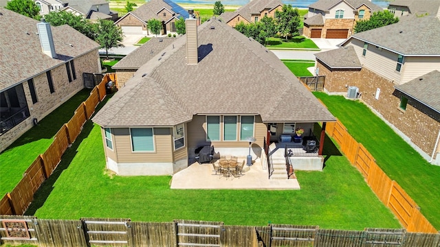 2928 San Milan Pass, Round Rock, TX 78665 - rear view of property featuring a shingled roof, a residential view, a chimney, and a patio