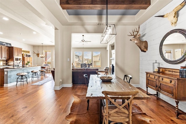 2928 San Milan Pass, Round Rock, TX 78665 - dining room with wood-type flooring, recessed lighting, a ceiling fan, and wooden walls