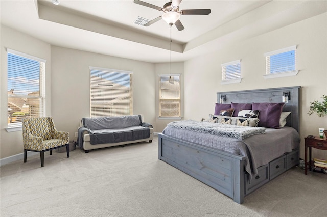 2928 San Milan Pass, Round Rock, TX 78665 - carpeted bedroom with a raised ceiling, multiple windows, and ceiling fan
