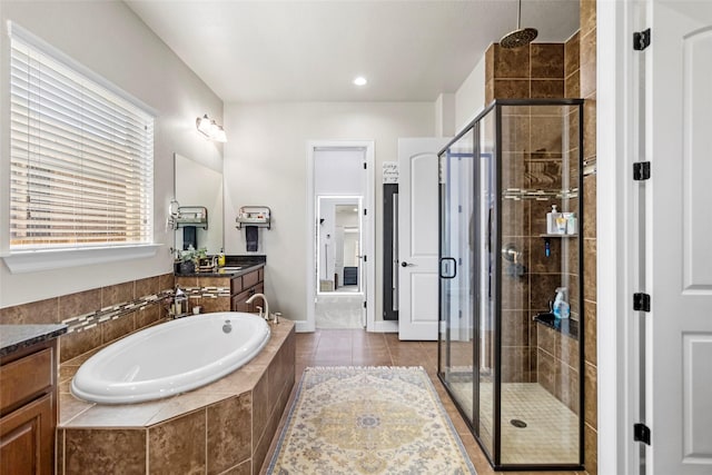 2928 San Milan Pass, Round Rock, TX 78665 - bathroom featuring vanity, a garden tub, a shower stall, and tile patterned flooring