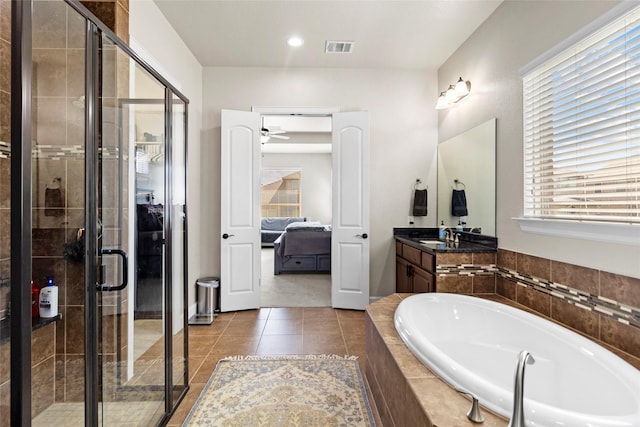 2928 San Milan Pass, Round Rock, TX 78665 - ensuite bathroom with a garden tub, vanity, a shower stall, tile patterned floors, and french doors