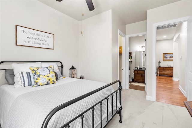 2928 San Milan Pass, Round Rock, TX 78665 - bedroom with light colored carpet, ensuite bathroom, and a ceiling fan