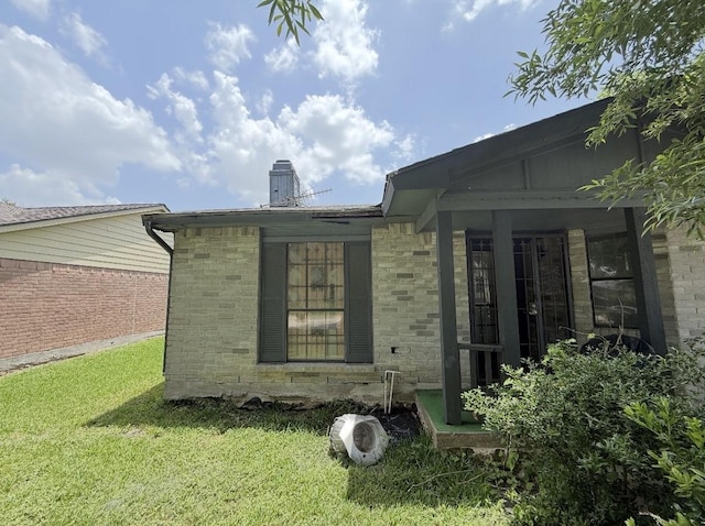 14138 Dartwood Dr, Houston, TX 77049 - view of side of property featuring a chimney, a lawn, and brick siding