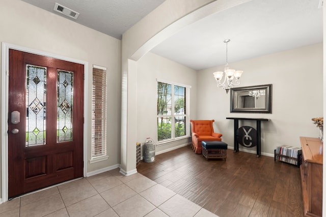 31820 Forest Oak Ln, Conroe, TX 77385 - foyer entrance featuring arched walkways, a chandelier, and light wood finished floors