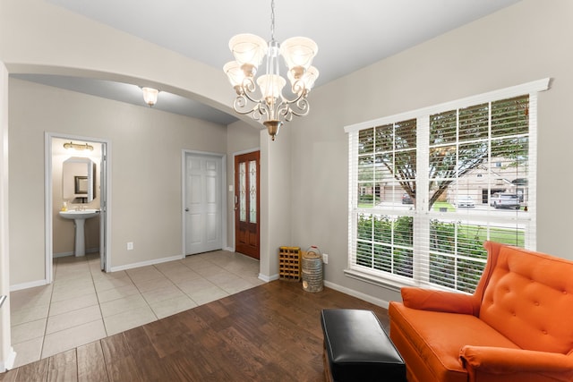 31820 Forest Oak Ln, Conroe, TX 77385 - foyer entrance featuring arched walkways, a chandelier, plenty of natural light, and light wood-style flooring