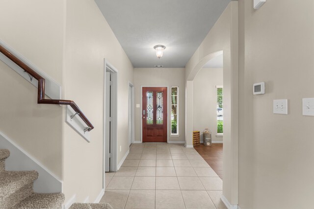 31820 Forest Oak Ln, Conroe, TX 77385 - entryway with arched walkways, stairs, and light tile patterned flooring