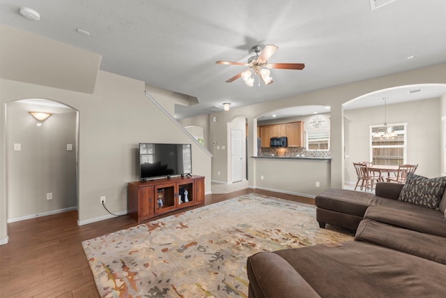 31820 Forest Oak Ln, Conroe, TX 77385 - living room featuring arched walkways, a ceiling fan, and wood finished floors