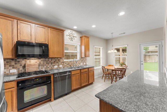 31820 Forest Oak Ln, Conroe, TX 77385 - kitchen with black appliances, decorative backsplash, recessed lighting, light tile patterned flooring, and dark stone countertops
