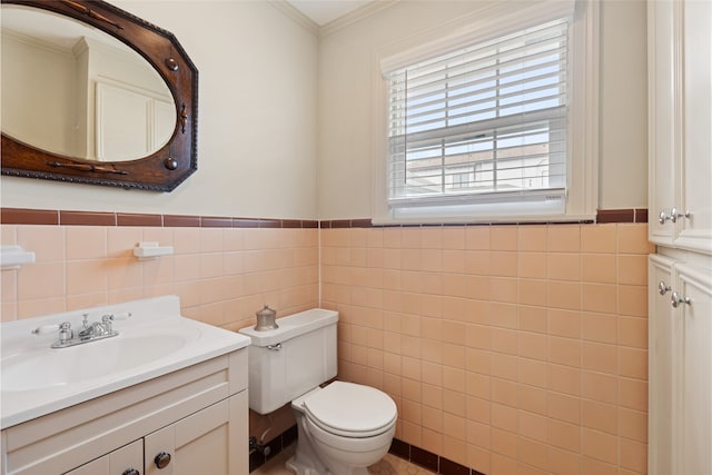 1311 Peden St, Houston, TX 77006 - bathroom with tile walls, vanity, a wainscoted wall, and crown molding