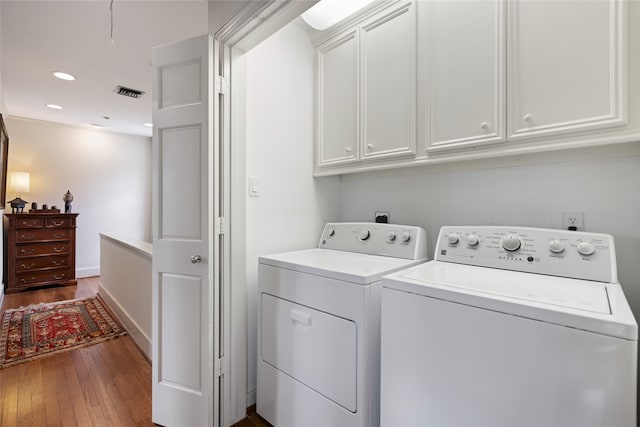 1311 Peden St, Houston, TX 77006 - laundry area with cabinet space, washing machine and clothes dryer, dark wood-type flooring, and recessed lighting