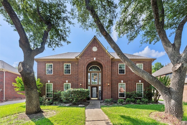 1711 Alcorn Bayou Dr, Sugar Land, TX 77479 - traditional-style house featuring brick siding and a front lawn
