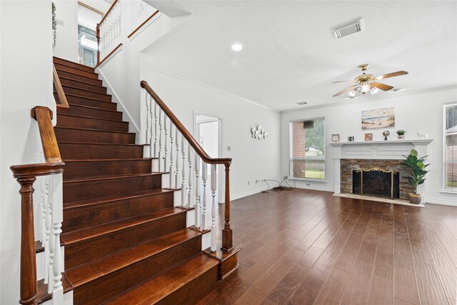 1711 Alcorn Bayou Dr, Sugar Land, TX 77479 - stairs featuring a ceiling fan, wood finished floors, crown molding, and a stone fireplace