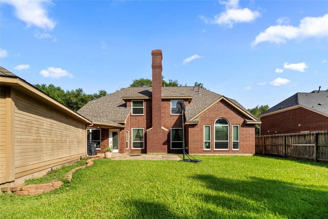 1711 Alcorn Bayou Dr, Sugar Land, TX 77479 - back of property featuring a fenced backyard, brick siding, a shingled roof, and a patio