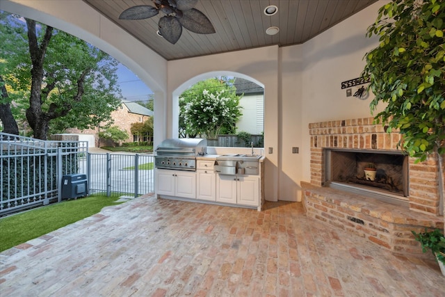 3001 Tangley Rd, West University Place, TX 77005 - view of patio featuring exterior kitchen, an outdoor brick fireplace, and a ceiling fan