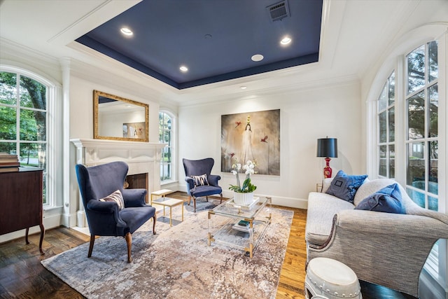 3001 Tangley Rd, West University Place, TX 77005 - living area with ornamental molding, a tray ceiling, a fireplace, and wood finished floors