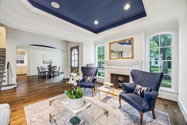 3001 Tangley Rd, West University Place, TX 77005 - living area featuring arched walkways, ornamental molding, a fireplace, a tray ceiling, and wood finished floors