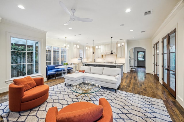 3001 Tangley Rd, West University Place, TX 77005 - living area featuring arched walkways, dark wood finished floors, crown molding, ceiling fan, and recessed lighting