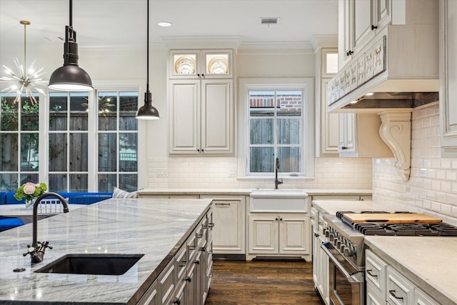 3001 Tangley Rd, West University Place, TX 77005 - kitchen featuring stainless steel range, light stone countertops, crown molding, pendant lighting, and dark wood-type flooring