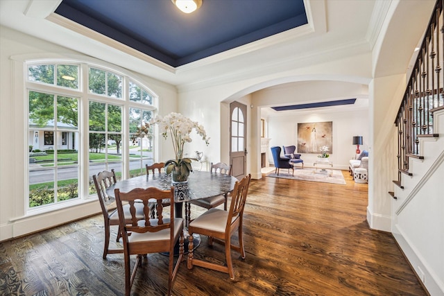 3001 Tangley Rd, West University Place, TX 77005 - dining space featuring arched walkways, ornamental molding, a tray ceiling, stairs, and wood finished floors